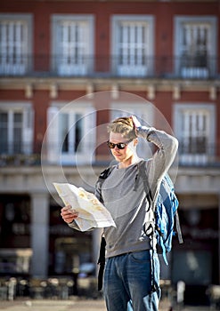 Young student backpacker tourist looking city map lost and confused in travel destination