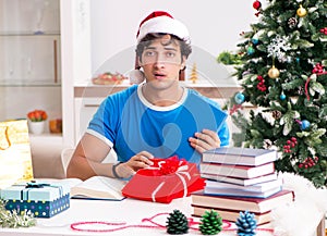 Young student with book at Christmas eve