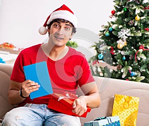 Young student with book at Christmas eve