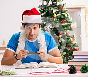 Young student with book at Christmas eve