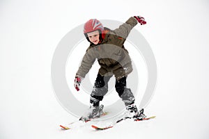 Young student boy practices ski sport moves. White snow background.