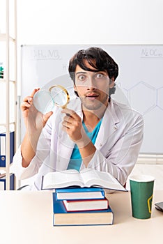 The young student chemist in the classroom