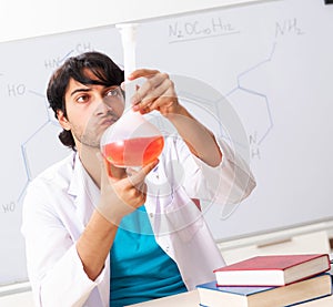 Young student chemist in the classroom