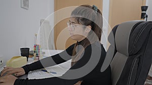 A young student of Colombian universitary sitting at a table and studying sincerely. Girl is studying at home.