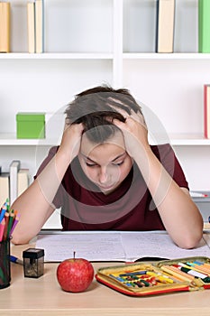 Young student desperate and overworked with homework at school