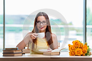 The young student drinking coffee while sudying