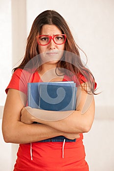Young student geek woman in red t shirt with yeyglasses dissappointed or stressed