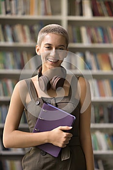Young Caucasian student girl posing in library