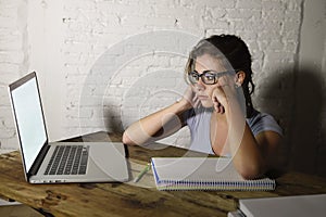 Young student girl studying tired at home laptop computer preparing exam exhausted and frustrated feeling stress