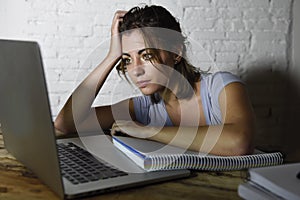 Young student girl studying tired at home laptop computer preparing exam exhausted and frustrated feeling stress