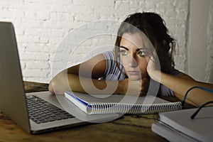 Young student girl studying tired at home laptop computer preparing exam exhausted and frustrated feeling stress