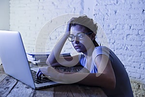 Young student girl studying tired at home laptop computer preparing exam exhausted and frustrated feeling stress