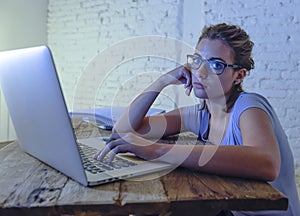 Young student girl studying tired at home laptop computer preparing exam exhausted and frustrated feeling stress