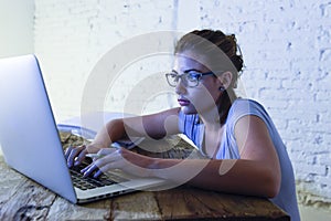 Young student girl studying tired at home laptop computer preparing exam exhausted and frustrated feeling stress