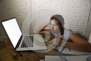 Young student girl studying tired at home laptop computer preparing exam exhausted and frustrated feeling stress