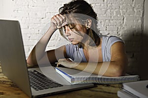 Young student girl studying tired at home laptop computer preparing exam exhausted and frustrated feeling stress