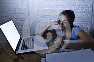 Young student girl studying tired at home laptop computer preparing exam exhausted and frustrated feeling stress