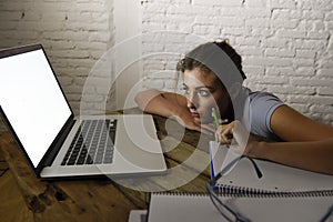 Young student girl studying tired at home laptop computer preparing exam exhausted and frustrated feeling stress