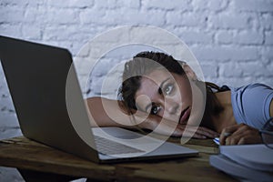 Young student girl studying tired at home laptop computer preparing exam exhausted and frustrated feeling stress