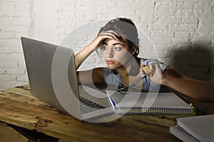 Young student girl studying tired at home laptop computer preparing exam exhausted and frustrated feeling stress