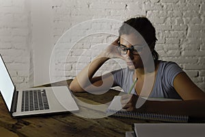 Young student girl studying tired at home laptop computer preparing exam exhausted and frustrated feeling stress