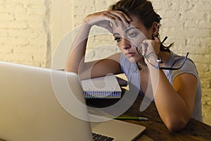 Young student girl studying tired at home laptop computer preparing exam exhausted and frustrated feeling stress