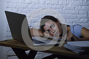 Young student girl studying tired at home laptop computer preparing exam exhausted and frustrated feeling stress