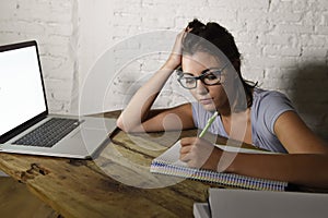 Young student girl studying tired at home laptop computer preparing exam exhausted and frustrated feeling stress