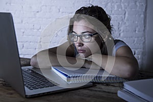 Young student girl studying tired at home laptop computer preparing exam exhausted and frustrated feeling stress