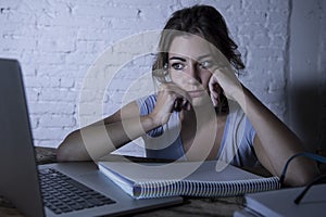 Young student girl studying tired at home laptop computer preparing exam exhausted and frustrated feeling stress