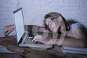 Young student girl studying tired at home laptop computer preparing exam exhausted and frustrated feeling stress