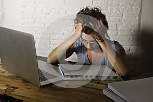 Young student girl studying tired at home laptop computer preparing exam exhausted and frustrated feeling stress