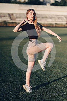 Young Student Goes in for Sports at the Stadium. Mod Kneel Up at the Stadium. Train Your Body