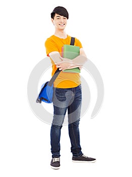 Young student holding books and slanting knapsack
