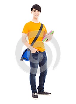 Young student holding books and slanting knapsack photo