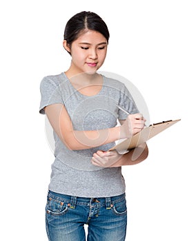 Young student jot down the information on clipboard