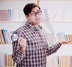 Young student looking for books in college library