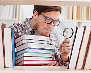 Young student looking for books in college library