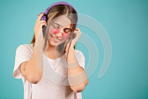 Young student is mad at music from headphones