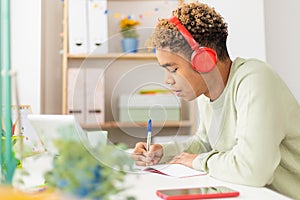 Young student man studying online with digital tablet in his studio room