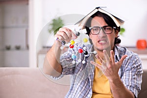 The young student physicist preparing for exam at home