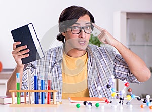 Young student physicist preparing for exam at home