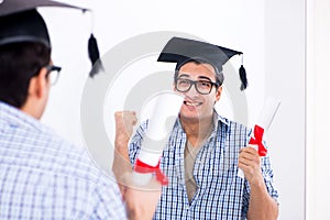 The young student planning graduation speech in front of mirror