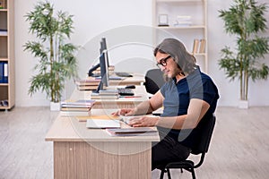 Young male student preparing for exams in the classroom