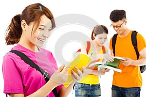 Young student read a book with classmates