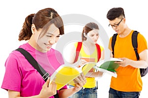 Young student read a book with classmates