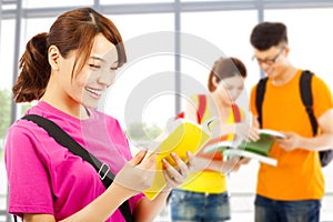 Young student read a book with classmates at school