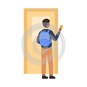 Young student standing in front of closed door, pressing doorbell, rear view