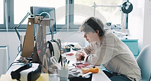 Young student using a 3D printer