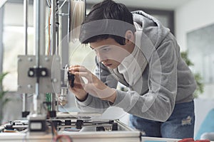 Young student using a 3D printer